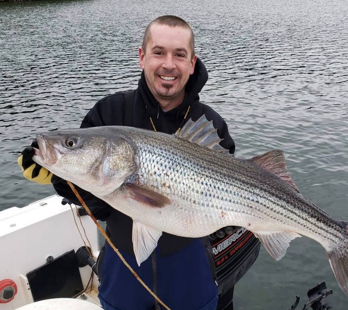Captain Tommy Moore with trophy striper